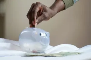 A kid saving with piggy bank